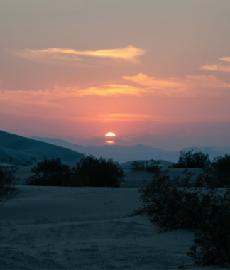 Sunset over desert dunes landscape