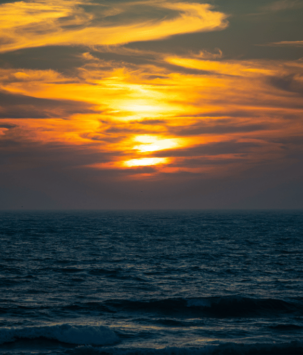 Sunset over a dark ocean