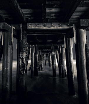 View underneath a boardwalk pier at the ocean