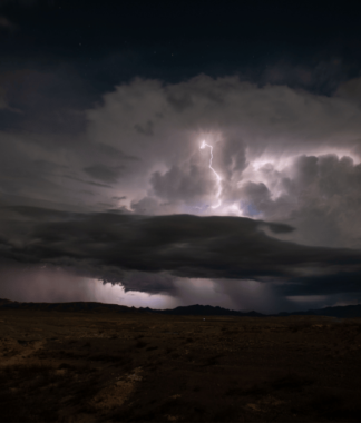 Stormy sky with lightening over a desert landscape